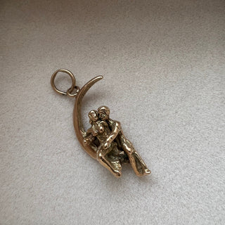 Antique C.P.S. Gold Charm of a couple sitting on a crescent moon